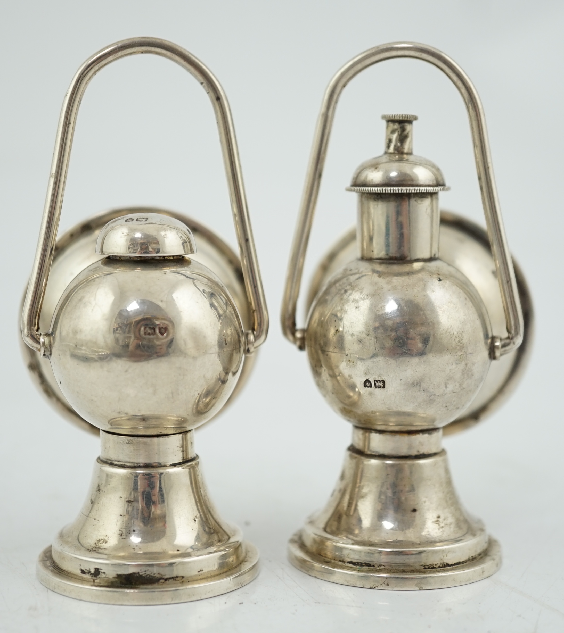 An Edwardian novelty cigar cutter and perpetual lighter, modelled as a pair of railway lamps, by Walker & Hall